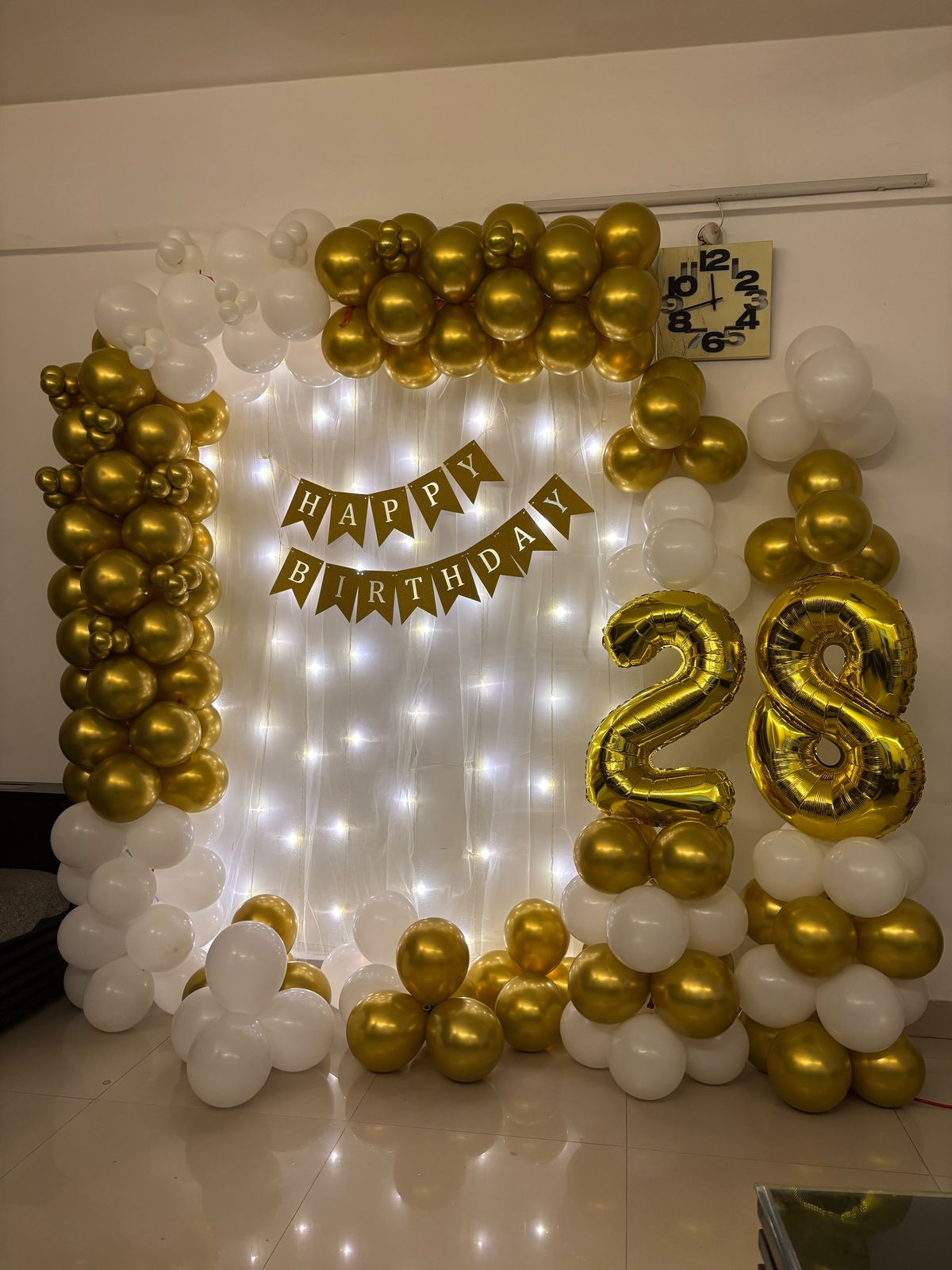 28th birthday decoration with white and golden balloon arch 